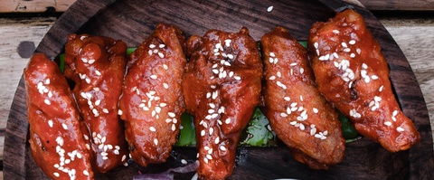 chicken drumsticks in sauce with sesame seeds