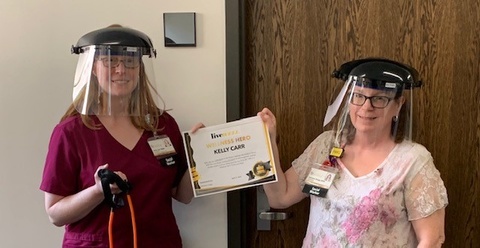 Wellness Hero Kelly Carr Accepting her Award while wearing personal protective equipment