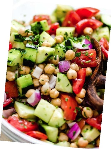 Salad of chickpeas, parsley, tomatoes, and cucumbers.