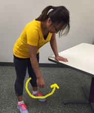 Woman performing shoulder-stretching exercise