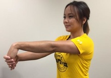 Woman performing wrist-stretching exercise