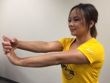 Woman performing wrist-stretching exercise