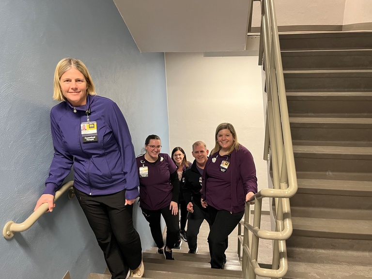 Photo of Live Healthy Iowa team (4 individuals standing on stairs)