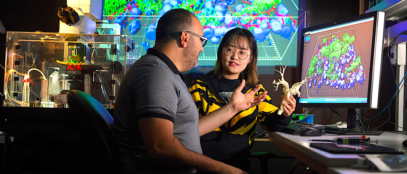 Student and faculty member in lab.