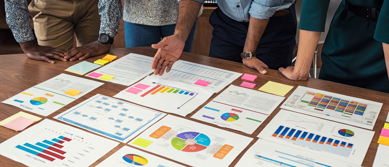 Photo of table with charts spread out.