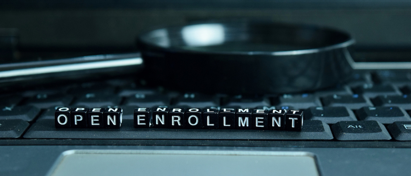 Letters on a keyboard spelling out "open enrollment"