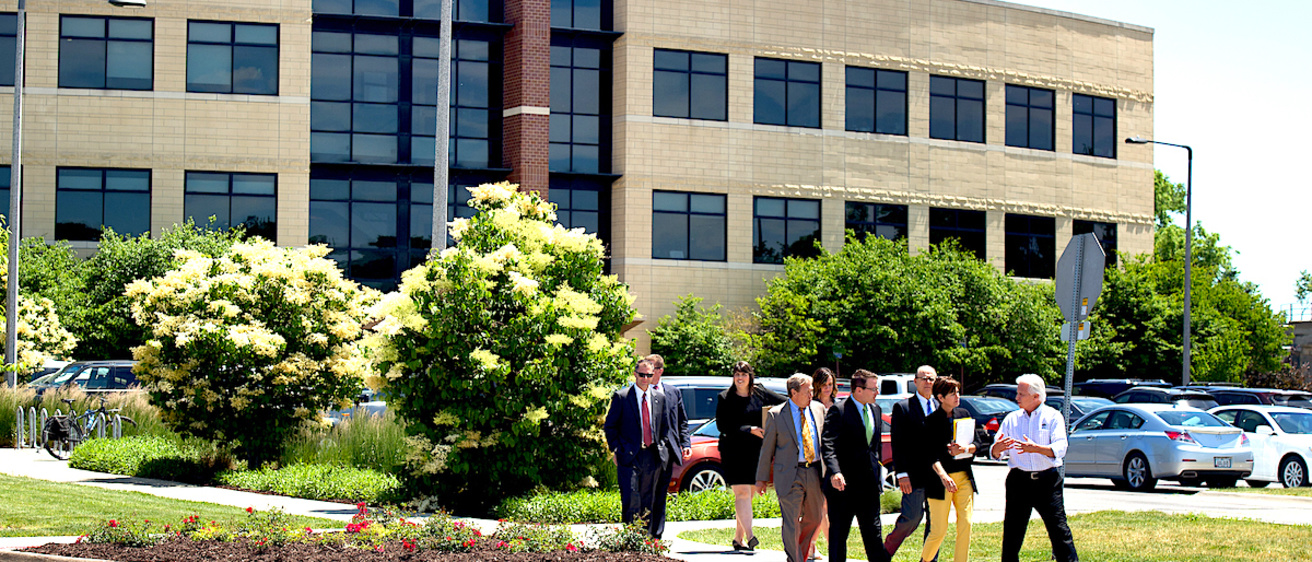 Group of people crossing the street outside the University Services Building