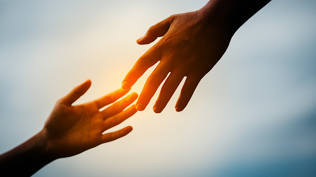 Hands reaching out to help each other.