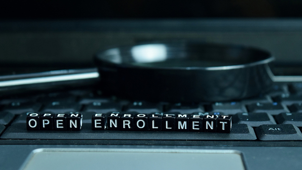 Letters on a keyboard spelling out "open enrollment"