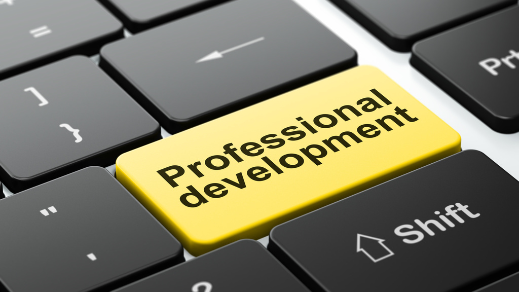 Professional Development return key in gold on black keyboard