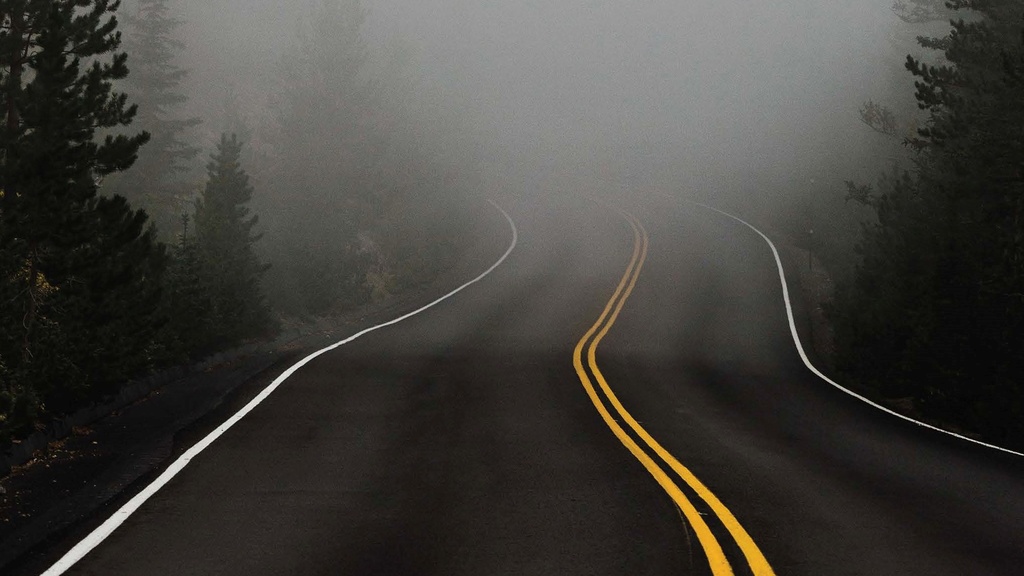 curvy road fading into white midst