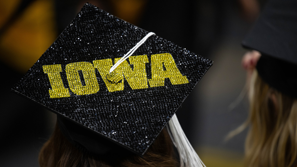 Graduation cap that reads Iowa in bold gold letters