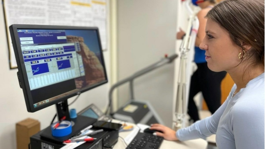 student performing health test, viewing screen with results