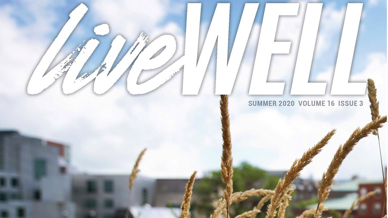 Graphic of "liveWELL" logo in front of UI campus building and blades of grass in the foreground.