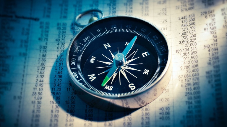 Compass laying on a list of coordinates